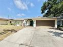 Single-story home with a two-car garage and neutral exterior paint, and a concrete driveway at 8630 134Th St, Seminole, FL 33776