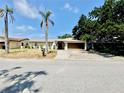A single-story home with a two-car garage, neutral exterior, and a mailbox in the front yard at 8630 134Th St, Seminole, FL 33776