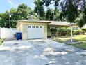 A house with a well-kept lawn and a long concrete driveway leading to the single-car garage at 9797 52Nd N Ter, St Petersburg, FL 33708