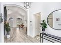 Bright foyer features wood-look floors, arched doorways and modern lighting fixture at 10112 Downey Ln, Tampa, FL 33626