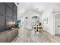 Spacious living room showcasing wood-look floors, vaulted ceilings, and abundance of natural light at 10112 Downey Ln, Tampa, FL 33626