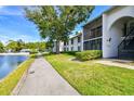 Inviting condo complex features screened lanais and a tranquil pond view with community pool at 1109 Pine Ridge W Cir # C1, Tarpon Springs, FL 34688