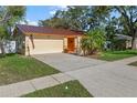 Home featuring a two-car garage and tidy landscaping at 11125 117Th St, Seminole, FL 33778
