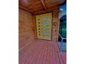 Stunning contemporary front door with glass panels, stained wood, and brushed metal handle at 13400 10Th St, Dade City, FL 33525