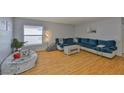 Spacious living room with hardwood floors and a large window that provides natural light at 13750 Fareham Rd, Odessa, FL 33556