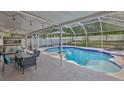 Inviting screened-in pool area with an outdoor dining set, ideal for entertaining and relaxation at 13750 Fareham Rd, Odessa, FL 33556