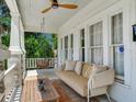 Relaxing front porch with a comfortable seating area and ceiling fan at 1423 Dr Martin Luther King Jr N St, St Petersburg, FL 33704