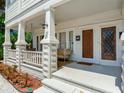 Inviting front porch features a swing, sitting area, and detailed stonework at 1423 Dr Martin Luther King Jr N St, St Petersburg, FL 33704