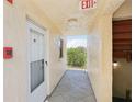 Hallway view leading to the unit with a view of the outside at 14401 Gulf Blvd # 106, Madeira Beach, FL 33708