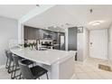 Modern kitchen featuring stylish counter seating and stainless steel appliances at 14401 Gulf Blvd # 106, Madeira Beach, FL 33708