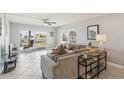 Bright living room with sliding doors to the patio with beach views at 14401 Gulf Blvd # 106, Madeira Beach, FL 33708