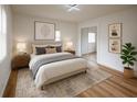 Serene bedroom with neutral tones, soft lighting, stylish decor, and a comfortable queen-sized bed at 1820 Douglas Ave, Clearwater, FL 33755
