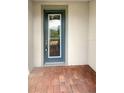 Close-up of a stylish front door with decorative glass and secure locking mechanisms, on a brick-paved porch at 19664 Ship Wheel Way, Land O Lakes, FL 34638