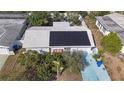 Charming home with solar panels, landscaped yard, and a vibrant blue driveway at 2066 High Ridge Dr, Clearwater, FL 33763