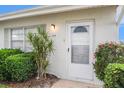 Close-up of the front door, showcasing the well-lit entry and neat landscaping at 301 Andover S Pl # 175, Sun City Center, FL 33573