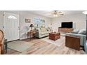 Inviting living room with wood flooring, neutral tones, and comfortable seating at 301 Andover S Pl # 175, Sun City Center, FL 33573