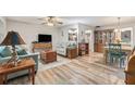 Open-concept living area with wood floors, stylish furnishings, and seamless flow at 301 Andover S Pl # 175, Sun City Center, FL 33573