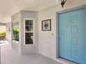 Light-blue front door with adjacent window for natural light at 3509 Oak Lake Dr, Palm Harbor, FL 34684