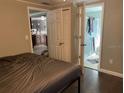 Bedroom showcasing hardwood floors, gray walls, and view to ensuite bathroom and kitchen at 3512 16Th E St, Bradenton, FL 34208