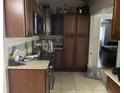 Kitchen features dark wood cabinetry, granite countertops, and tile flooring at 3512 16Th E St, Bradenton, FL 34208