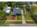 An aerial shot showcases the home's fenced yard, landscaping, and nearby street at 433 Pineapple St, Tarpon Springs, FL 34689