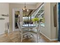 Cozy breakfast nook featuring a view of the screened pool and lanai at 4530 Roanoak Way, Palm Harbor, FL 34685
