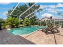 Sparkling screened pool with lush landscaping and brick paved deck, perfect for relaxation and entertainment at 4530 Roanoak Way, Palm Harbor, FL 34685