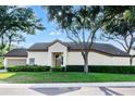 Lovely property boasting a manicured lawn, mature trees, and an attached garage at 5205 Fairway One Dr, Valrico, FL 33596