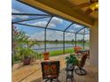 Enjoy the beautiful lake view from this screened in patio with plenty of room for seating and dining at 5532 Sunset Falls Dr, Apollo Beach, FL 33572