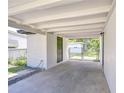 Spacious carport area with a covered area, an enclosed storage room, and a gated entrance at 6004 S 82Nd St, Tampa, FL 33619