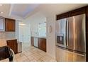 Modern kitchen featuring stainless steel appliances, wood cabinets and tile floors at 6265 Sun Blvd # 1203, St Petersburg, FL 33715