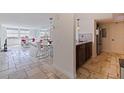 Open living space with stone floors, well lit dining area and comfortable white couch at 6265 Sun Blvd # 1203, St Petersburg, FL 33715