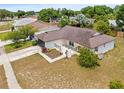 An elevated view showcasing the home's layout, landscaping, and neighborhood surroundings on a sunny day at 6826 Rosemary Dr, Tampa, FL 33625