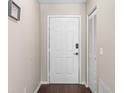 Welcoming entryway with a white front door, closet, and sleek flooring, creating a clean and inviting ambiance at 6826 Rosemary Dr, Tampa, FL 33625
