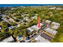 Aerial view showcasing the condo community's lush surroundings and proximity to the water at 704 Lyndhurst St # 624, Dunedin, FL 34698
