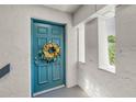 Welcoming front door with seasonal wreath and sidelight window at 704 Lyndhurst St # 624, Dunedin, FL 34698