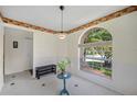 Cozy dining area featuring a large window and a casual bench at 8980 Antigua Dr, Seminole, FL 33777