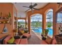 Relaxing lanai with comfortable seating overlooking a sparkling swimming pool and waterfront canal at 920 Symphony Isles Blvd, Apollo Beach, FL 33572
