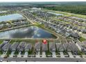 Aerial view of the property within a beautiful community with scenic ponds and well-maintained homes at 9423 Lemon Drop Loop, Sun City Center, FL 33573