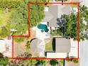 An overhead view reveals a home with a pool, spa, lush greenery, and generous lot lines outlined in red at 11988 117Th St, Seminole, FL 33778