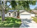 Charming single-story home with a well-maintained lawn and a two-car garage at 11988 117Th St, Seminole, FL 33778