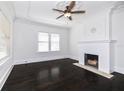 Bright living room with dark hardwood floors and a decorative tiled fireplace at 1203 E New Orleans Ave, Tampa, FL 33603
