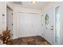 Bright entryway with ceramic tile floors, a storage closet and a beautiful stained-glass window in the door at 12873 Cumberland Dr, Largo, FL 33773