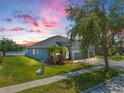 Beautifully landscaped home with a three-car garage near a serene lake at 13336 Graham Yarden Dr, Riverview, FL 33579