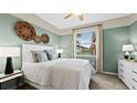 Relaxing bedroom with soft colors, carpeted floor, and a large window providing natural light at 15127 Oxford Grey Dr, Bradenton, FL 34211