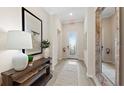 Inviting entryway with tile flooring, a decorative mirror, and a view of the front door at 15127 Oxford Grey Dr, Bradenton, FL 34211