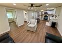Bright, open living area with wood floors flowing into a modern kitchen and well-appointed bathroom at 18452 Fort Dade Ave, Brooksville, FL 34601
