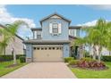 Charming two-story home featuring a two-car garage, stone accents, and well-manicured landscaping at 19191 Pease Pl, Lutz, FL 33558
