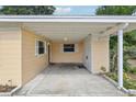 Covered carport featuring painted ceiling, convenient storage, and bright natural light at 2044 Temple Ter, Clearwater, FL 33764