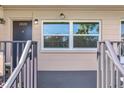 Condo entrance with fresh paint, modern lighting, and a bright window that offers views to the outside at 216 36Th N Ave # 202B, St Petersburg, FL 33704